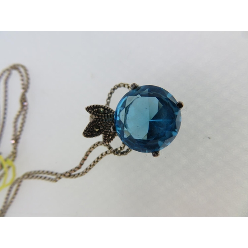 196 - A blue stone brilliant cut pendant set in silver on a silver chain