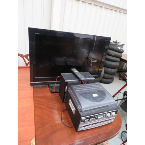 107 - Sony 26 inch TV with remote on stand, a radio CD turntable plus records etc