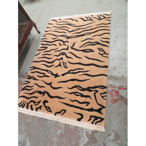 16 - Rug in the form of tiger stripes, approx 76 inches x 48 inches