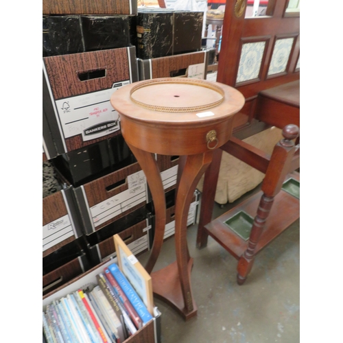 26 - Wooden pot stand with three sabre legs with brass furniture