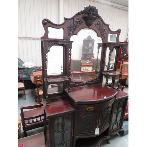 84 - Large sideboard with heavily carved front and top, with large bevel edged glass mirror, cupboards an... 