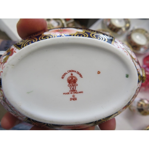 45 - A pair of Royal Crown Derby Imari pattern oval two handled urns with a matching cream jug