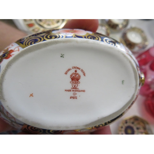 45 - A pair of Royal Crown Derby Imari pattern oval two handled urns with a matching cream jug