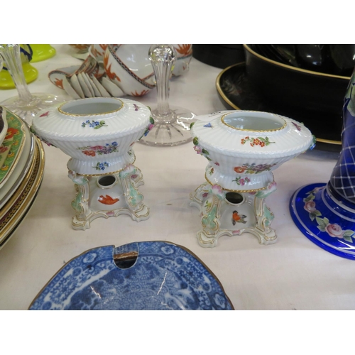 32 - A pretty pair of Meissen style porcelain urns on stands with hand painted decoration, crossed blue s... 