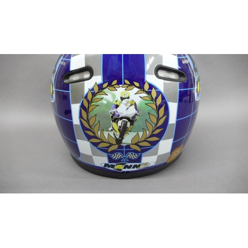 245 - An unused motorcycle helmet signed by John McGuiness