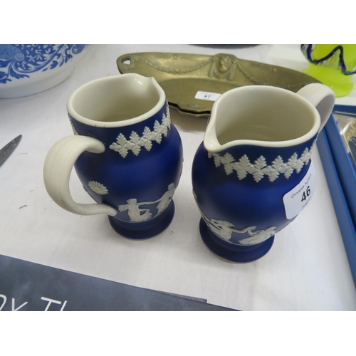 46 - Dark blue Jasperware jugs with decoration of dancing ladies (pair)