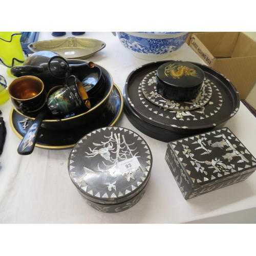 93 - A collection of black lacquered wooden bowls, trays, cups etc