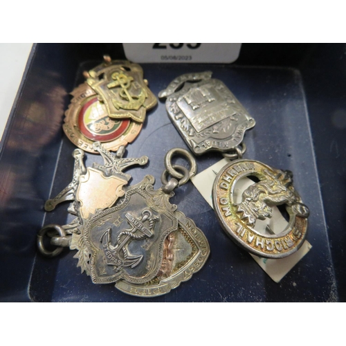 235 - A collection of badges and medals  including Naval and two gold Highland Games medals awarded to J C... 