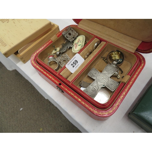 259 - A good quality red tooled leather jewellery box plus some items of ethnic jewellery within