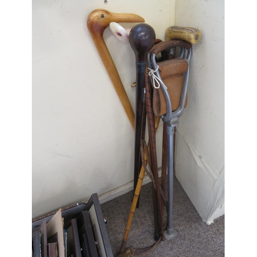 296 - A collection of shooting sticks, walking sticks and crops