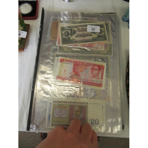 32 - A folder full of numerous world wide bank notes