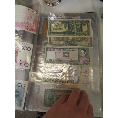 32 - A folder full of numerous world wide bank notes