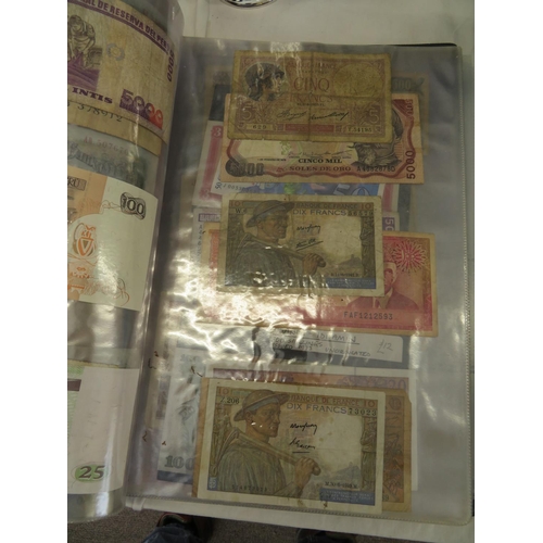 32 - A folder full of numerous world wide bank notes
