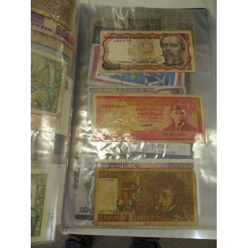 32 - A folder full of numerous world wide bank notes