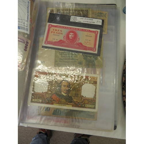 32 - A folder full of numerous world wide bank notes