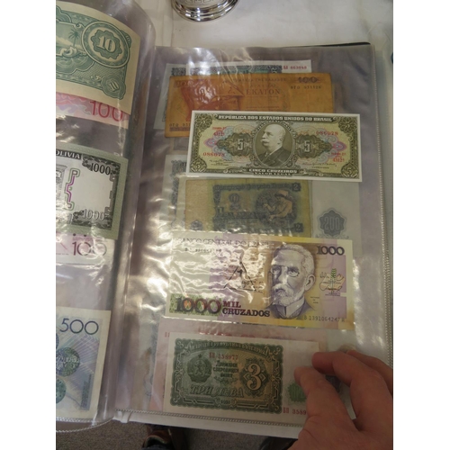 32 - A folder full of numerous world wide bank notes