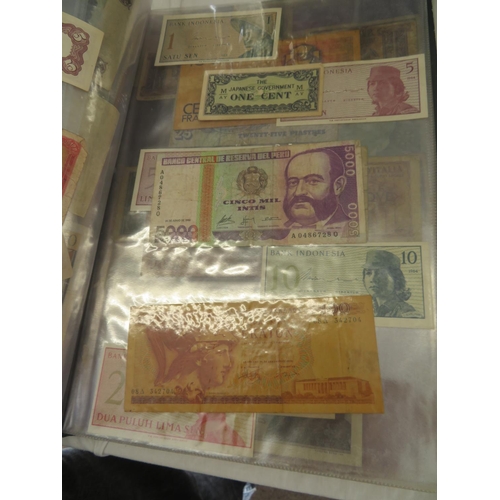 32 - A folder full of numerous world wide bank notes