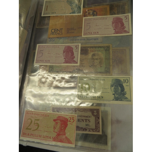 32 - A folder full of numerous world wide bank notes