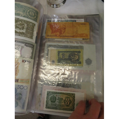 32 - A folder full of numerous world wide bank notes