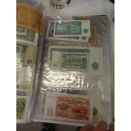 32 - A folder full of numerous world wide bank notes