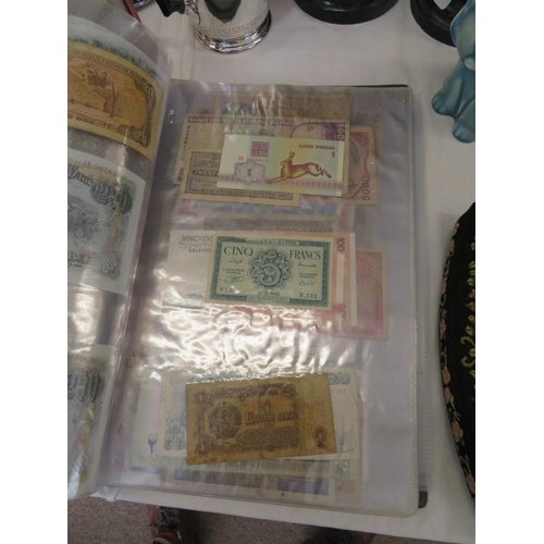 32 - A folder full of numerous world wide bank notes