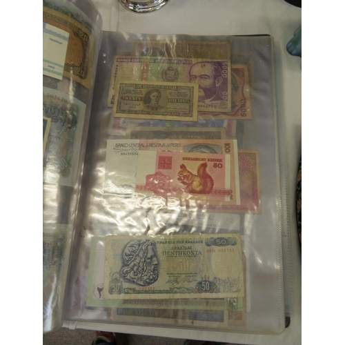 32 - A folder full of numerous world wide bank notes