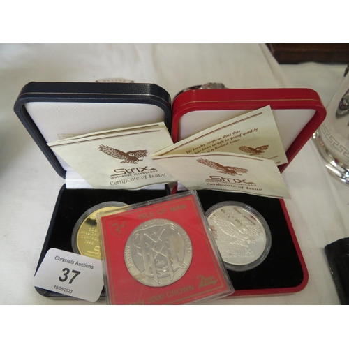 37 - Two Strix silver medallions together with an Isle of Man Millennium Crown