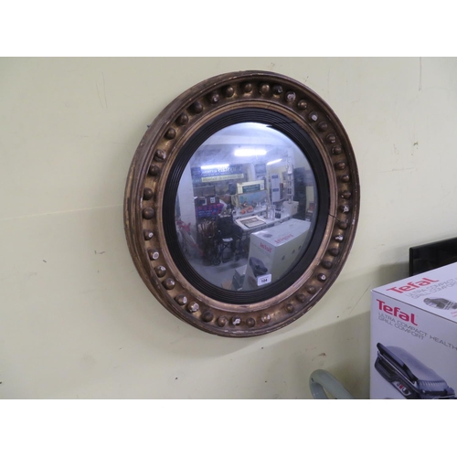 104 - Circular mirror in fancy gilt wood frame