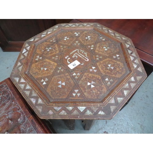 82 - Octagonal Far Eastern table on carved base and mother of pearl inlay, plus a storage box with carved... 