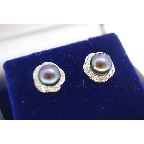 248 - Pair of 9ct Gold Black pearl ear studs with diamond surrounds