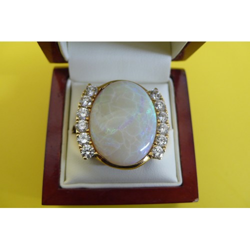 451 - An Impressive Large Oval Opal and Twelve Stone Diamond Ring Set in 18ct Gold. 
2.39ct of Diamonds, O... 