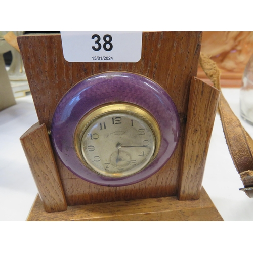 38 - Small enameled clock by Sir John Bennett Ltd, London set in wooden frame