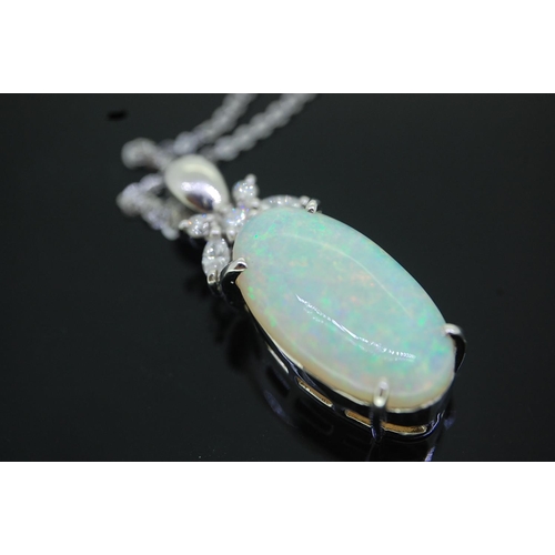 38 - Platinum pendant, oval cabochon opal with diamond decoration to top on a silver chain, Opal 6 carats... 