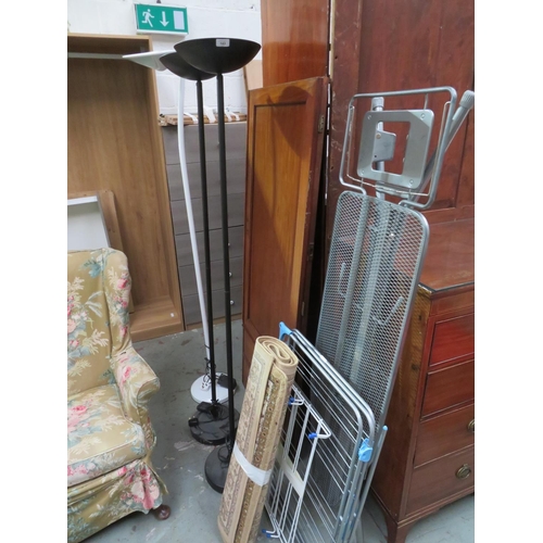 143 - Three floor lamps, an ironing board, airers and a rug