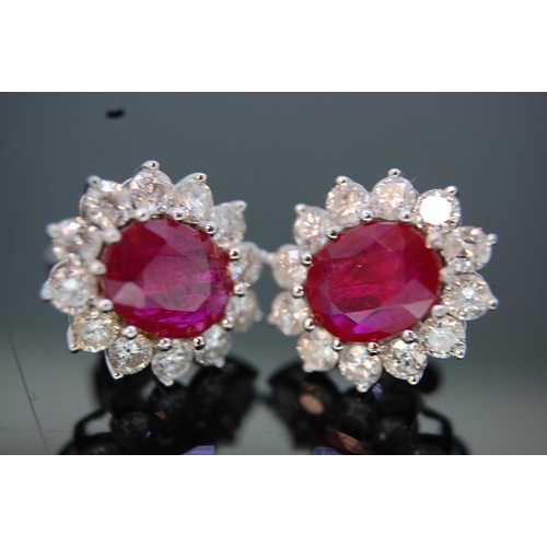 198 - Pair of large 18 ct. white gold oval ruby and diamond cluster ear studs (boxed).  Rubies 3.15 cts. t... 