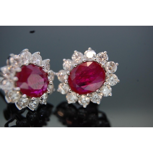 198 - Pair of large 18 ct. white gold oval ruby and diamond cluster ear studs (boxed).  Rubies 3.15 cts. t... 