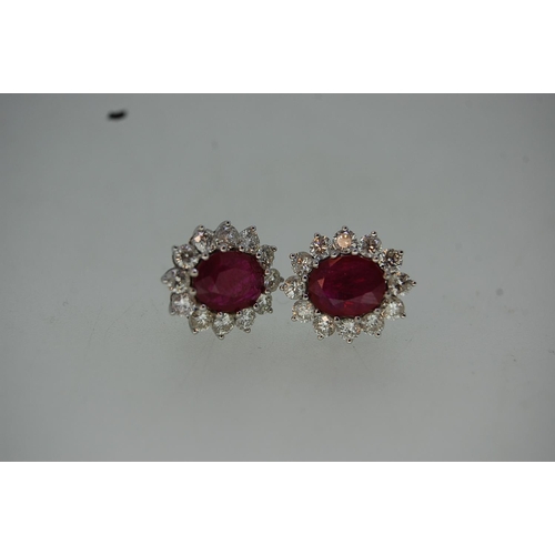 198 - Pair of large 18 ct. white gold oval ruby and diamond cluster ear studs (boxed).  Rubies 3.15 cts. t... 