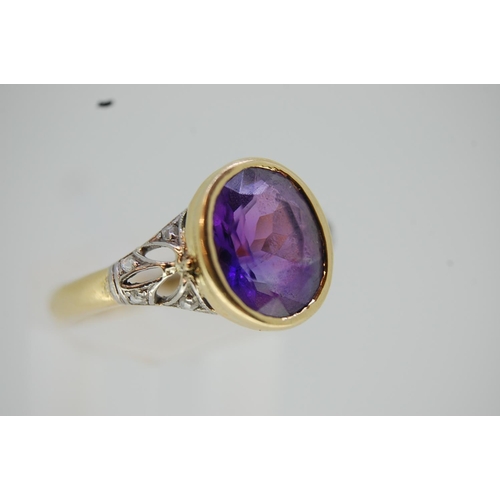 201 - 18 ct. gold oval amethyst ring with diamond cut shoulders - size O