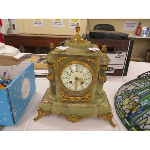 483 - A French green onyx mantel clock good quality chiming on a bell