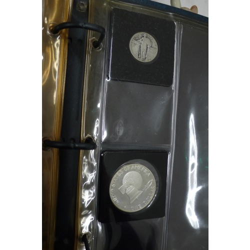 464 - An album containing United States silver coins together with collectors plates