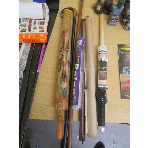 313 - Collection of walking sticks, an umbrella, lightsaber etc