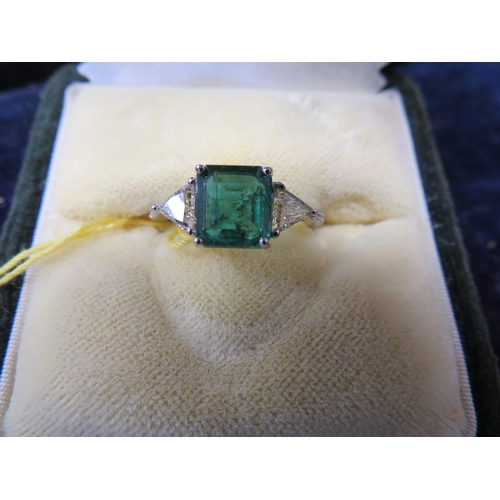 390 - 19 ct. white gold and square shaped emerald ring with triangular shaped diamond shoulders, emerald 1... 