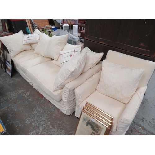 13 - Cream three seater settee and arm chair, plus numerous large cushions