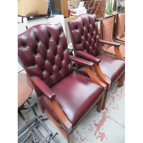 167 - Pair of burgundy leather button back and studded club chairs