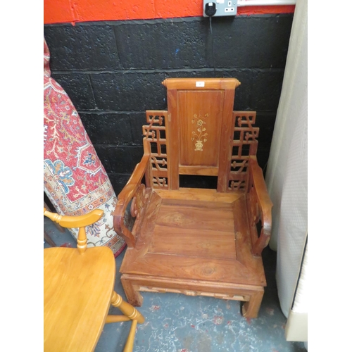 7 - Heavily carved and decorative low wooden chair in the Chinese style