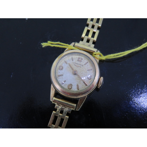 219 - Ladies' Longines wind up wrist watch with 9 ct. gold strap - total wt. 15.5 grms