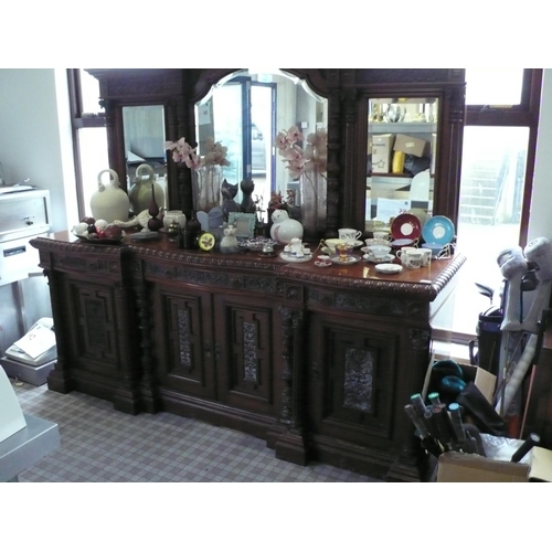 1 - Large heavily carved mahogany sideboard with bevel edged glass mirrored back