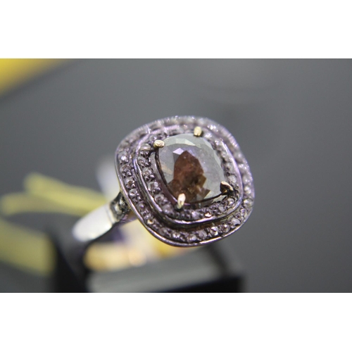 166 - Silver gilt dress ring set with fancy brown cushion cut diamond surrounded by two halos of diamonds