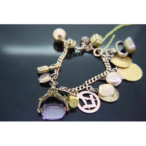 192 - Gold charm bracelet with eight gold charms and a pond and holf a pond coins, total weight 57grams