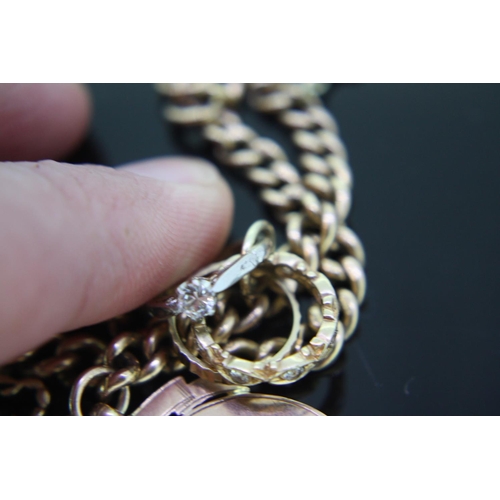 358 - Good 9ct gold charm necklace including diamond rings, Manx charms, all links marked, weight 52 grams